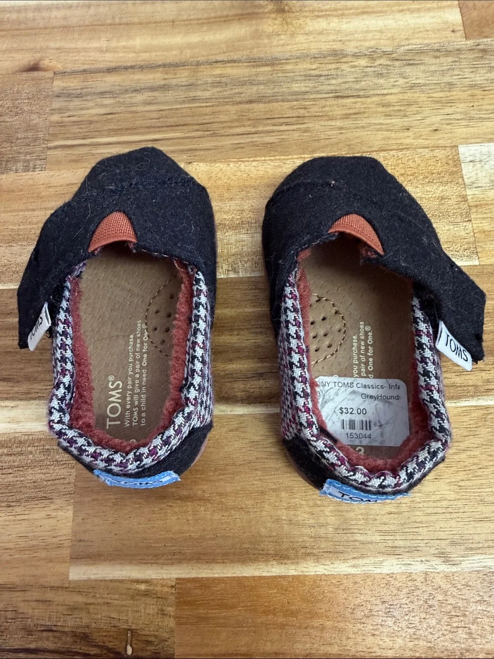 Toms Black Baby Slip-Ons with Rust Accent and Patterned Trim